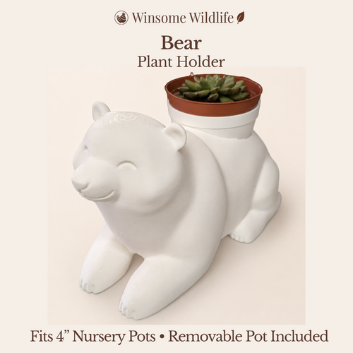 White bear-shaped plant holder with a removable pot on a beige background